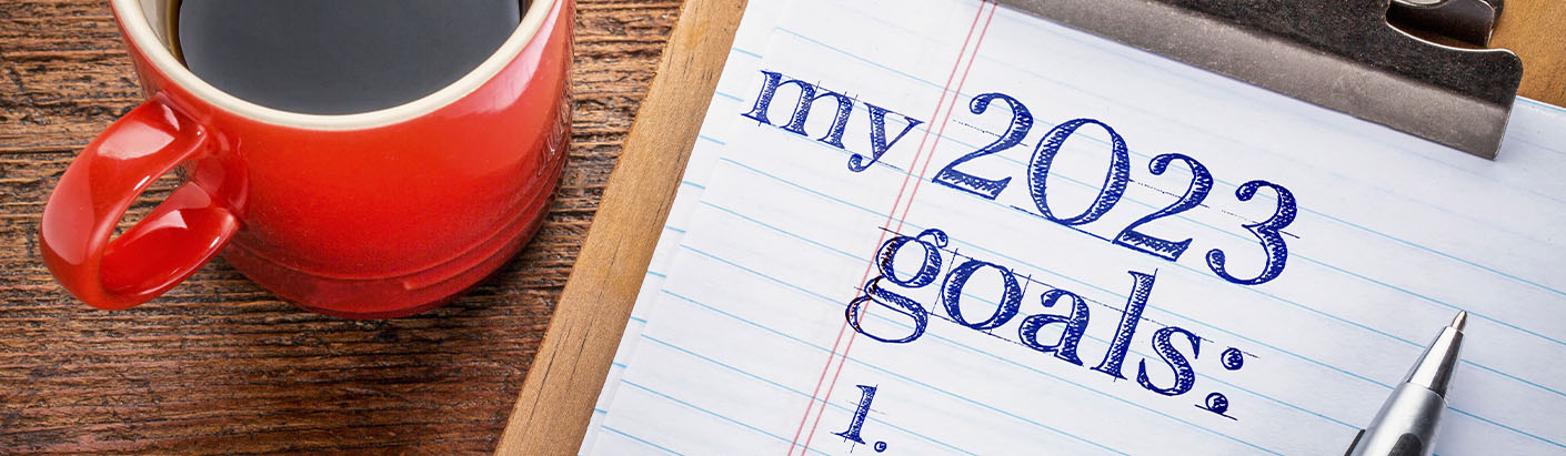 Financial goals list sitting on a table next to a cup of coffee.